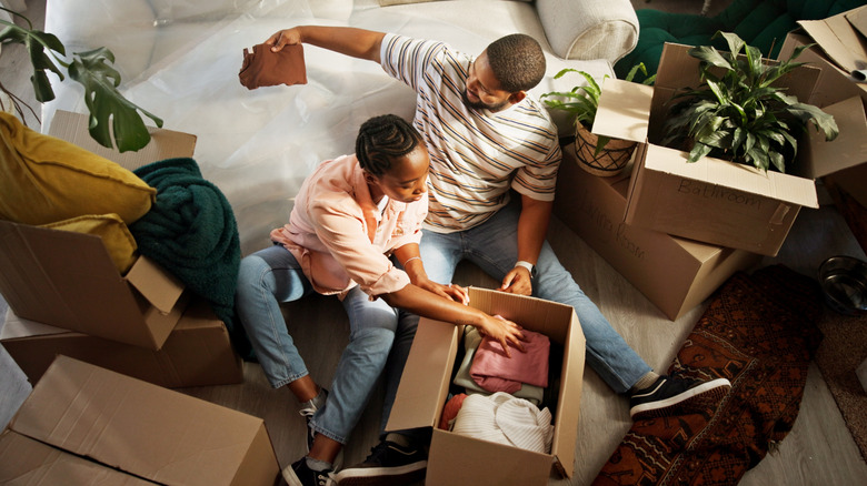 People moving boxes into a new home