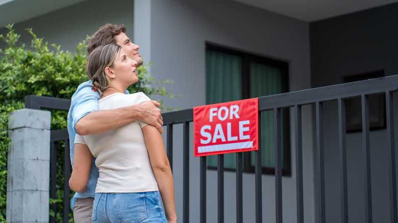 Young couple tours home for sale.